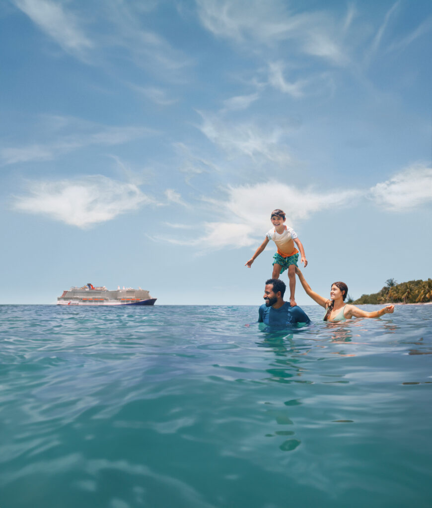 Family enjoying the water by a Carnival ship
